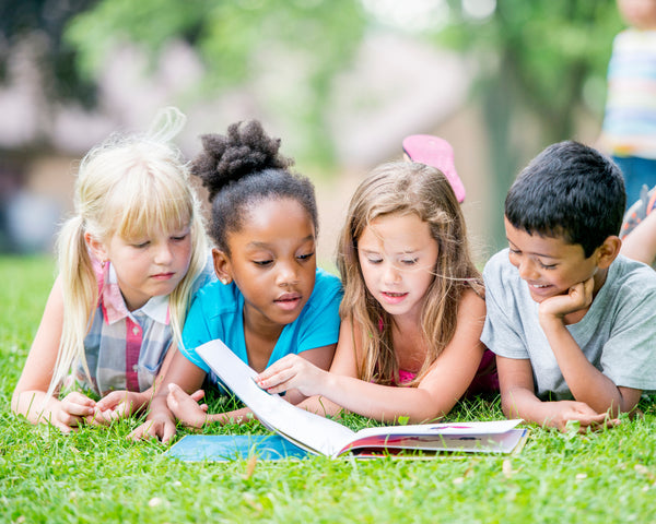 healthy kids are seen reading a book together