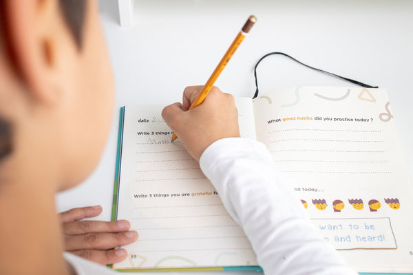 boy writing on his journal