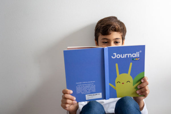 boy holding a journal for kids