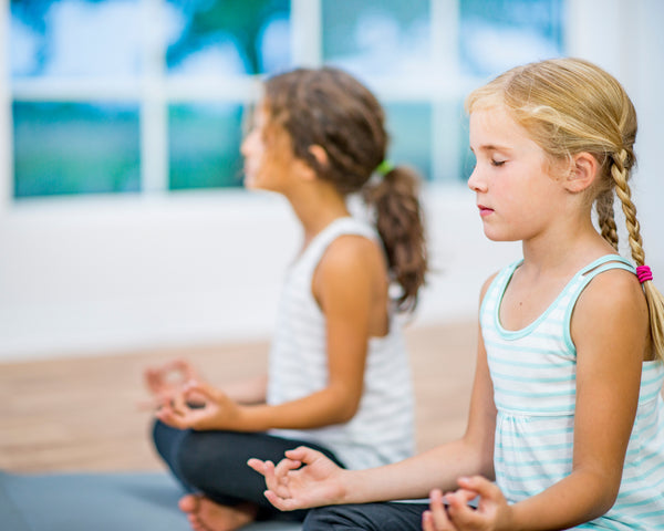 two girls meditating