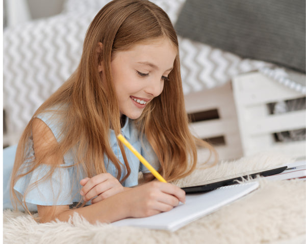 girl in 8th grade happily writing