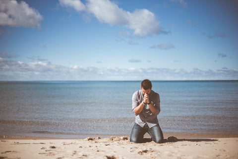 Photo of a man kneeling and praying for convicted by the holy spirit article for coffee and christ shop