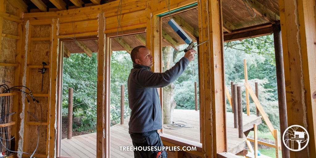 man building a treehouse