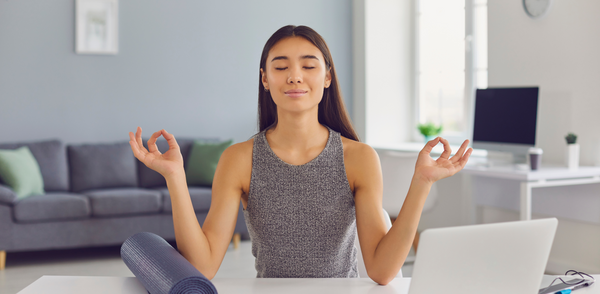 lady meditating at home office desk