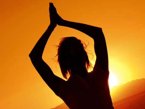 sun salutations is a yoga pose that enlivens the solar plexus chakra