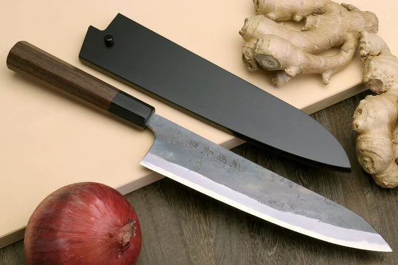 A chef's knife with a carbon steel blade.