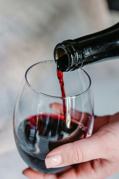 Red wine being poured into a wine glass