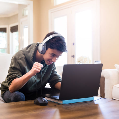 boy gaming on laptop