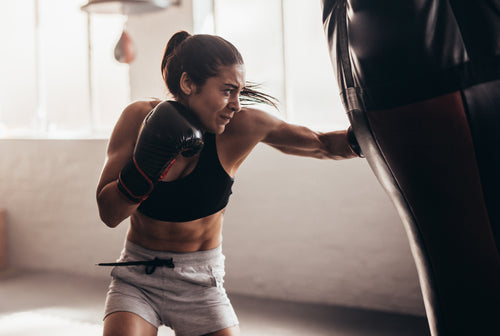 Supple-drink-supplements-woman-boxer-hitting-heavy-bag.jpg__PID:8ec0c15a-1e3b-4f43-bda6-7d1304002ce0