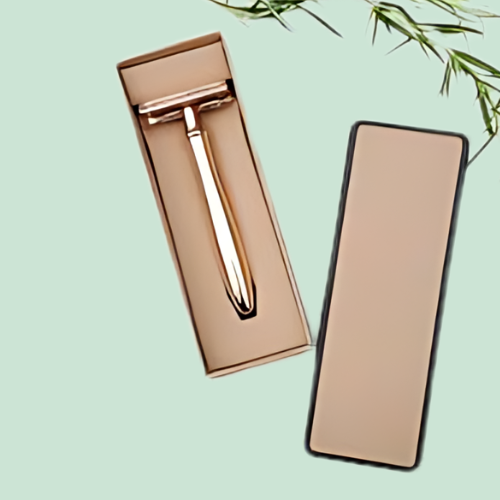 Rose gold razor in its box on a mint background.