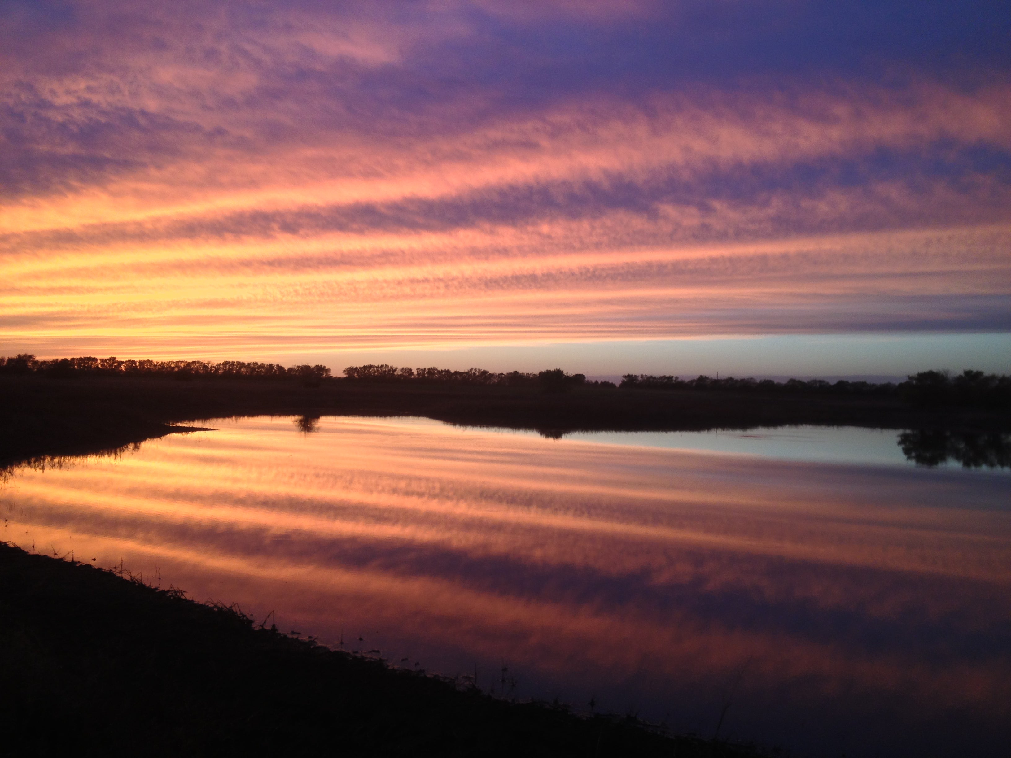 Beautiful sunset reflection on a farm pond