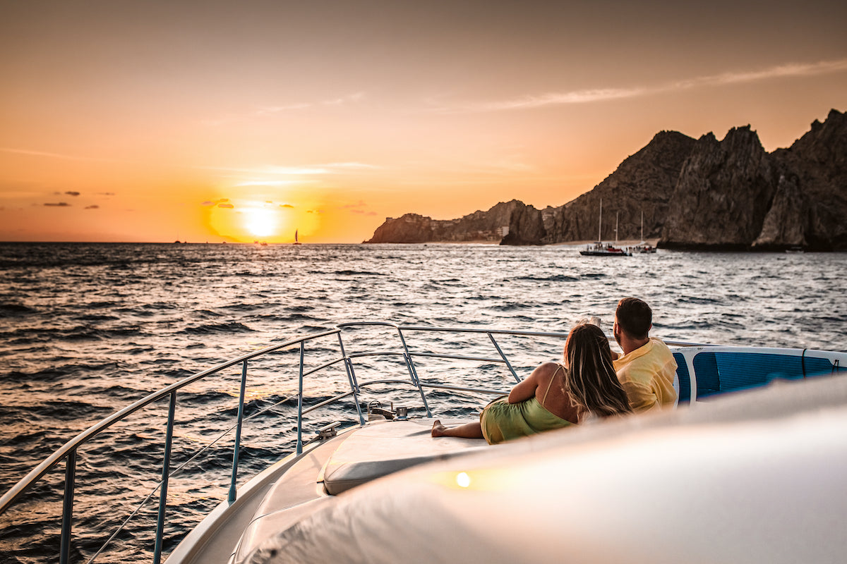 Photo of couple watching sunset on a yacht