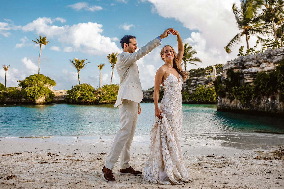 Bride and groom dancing on the beach after their wedding ceremony