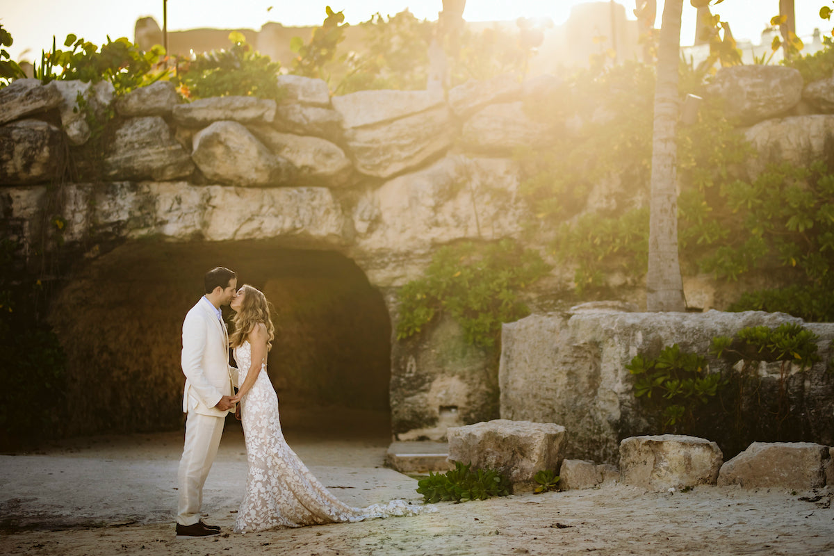 Just married couple kissing with sunset