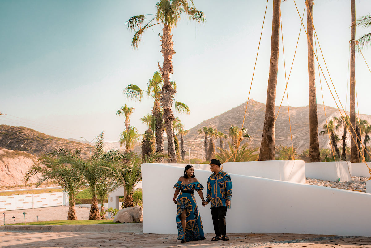 Photo of couple at holding hands and looking at each other