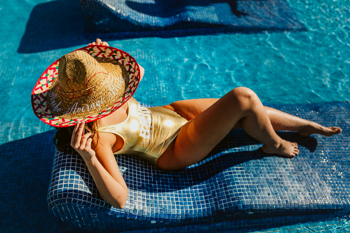 Bride lying on the pool at Vidanta Los Cabos