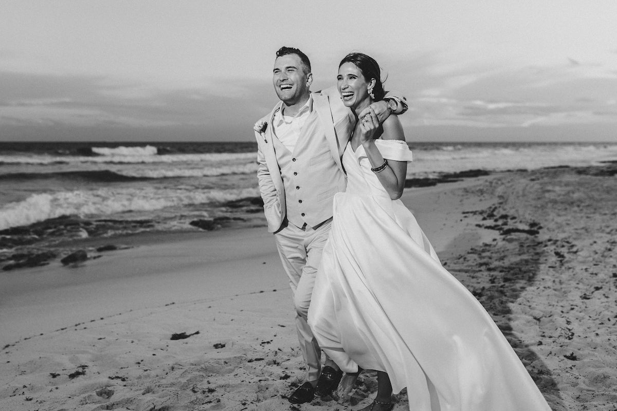 newlyweds posing on the beach