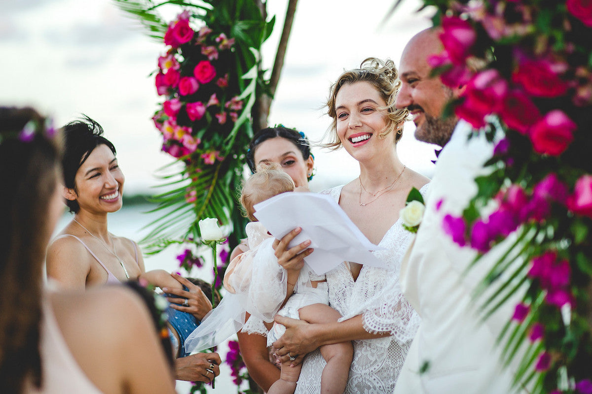 bride with his baby during the ceremony