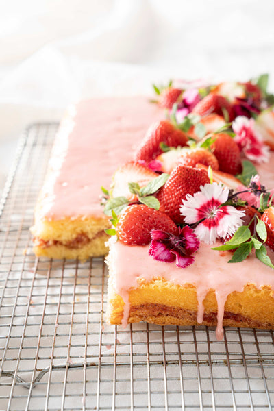 Strawberry honey bun cake on a cooling rack.