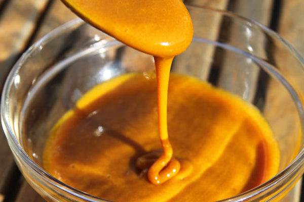 Honey and turmeric mixed in a bowl