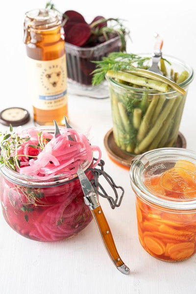 Jars of pickled vegetables and a jar of Sourwood honey.