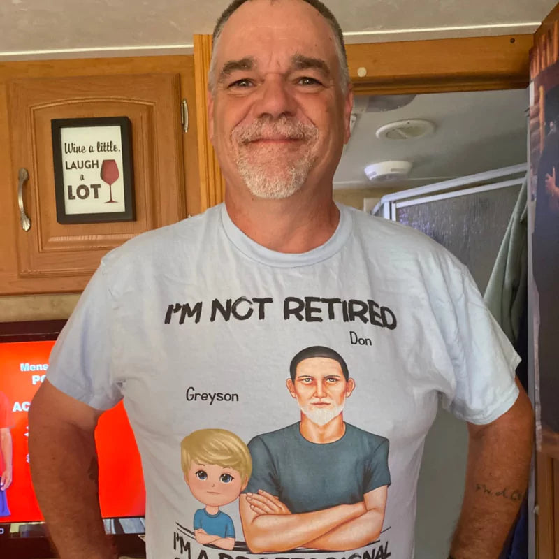 Man smiling, wearing a custom t-shirt with printed text and graphics celebrating his role as a grandfather.