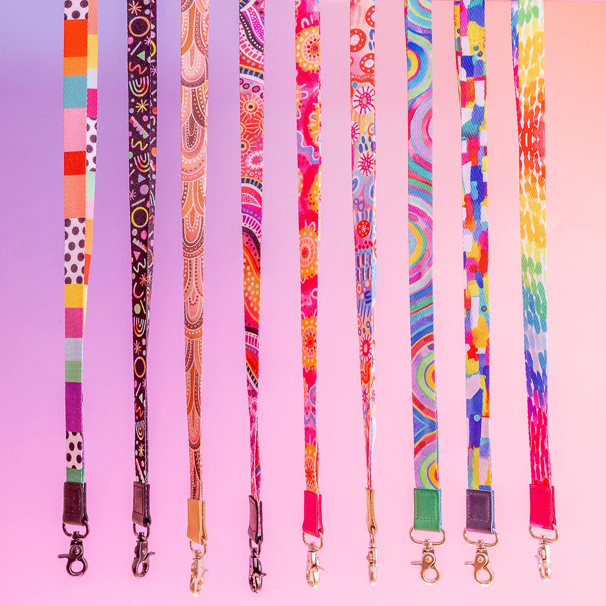 Colourful lanyards all in a line against a purple gradient background