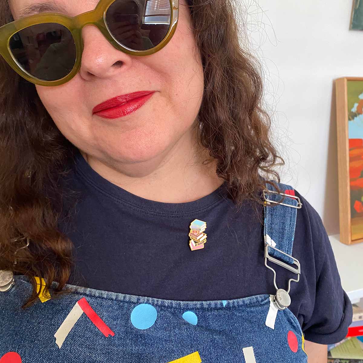 Cheryl Orsini wearing books enamel pin