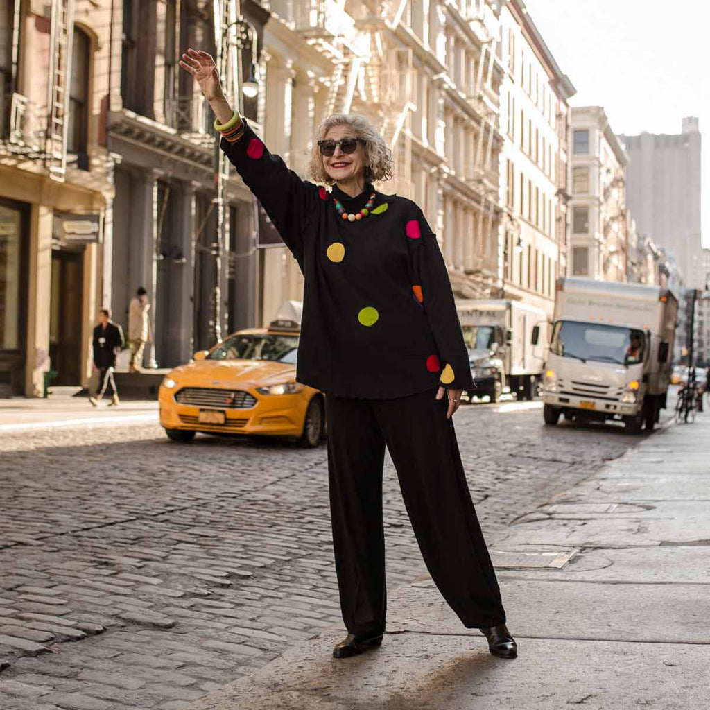 Dayle from Artful City Style Hailing a Cab in New York City wearing colorful Ruby Olive Jewelry