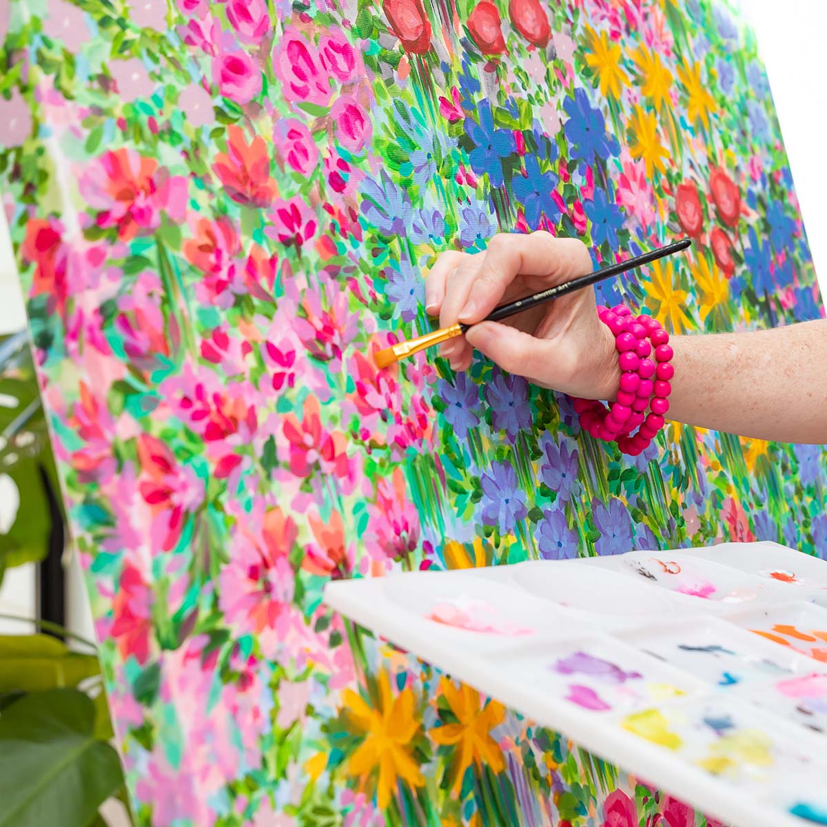 Sam Matthews Painting on her floral Canvas