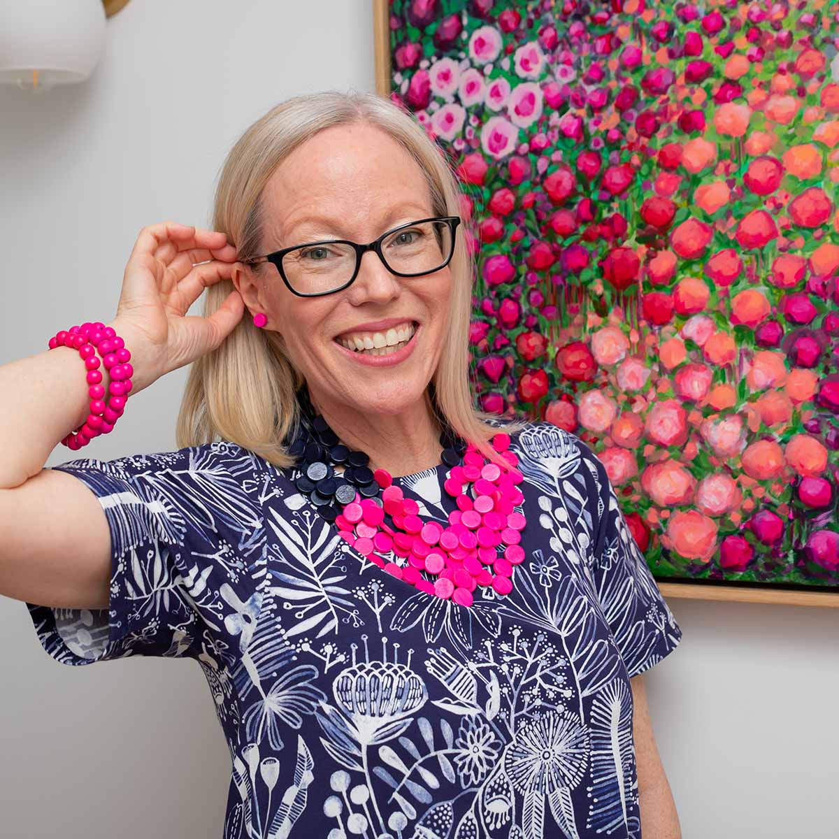 Sam Matthews wearing a blue and white shirt dress with bright pink accessories