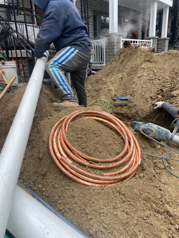 "Plumber from Mele Plumbing Services in Toronto replacing a drain pipe."