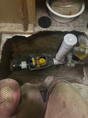 "Plumber from Mele Plumbing Services in Toronto performing backwater valve maintenance to prevent flooding and protect properties."