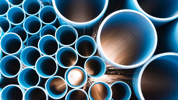 stack of blue plumbing pvc pipe in various sizes