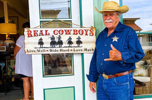 A paniolo (cowboy) throws a shaka.