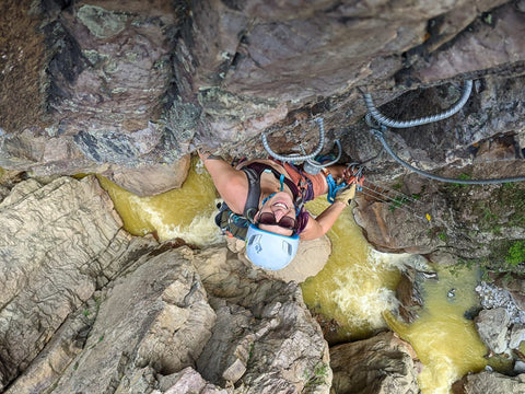 A female climber ascending a rocky wall.