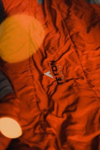 A closeup of a TETON Sports sleeping bag in red.