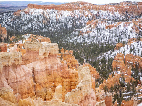 Red rock canyons and hoodoos in Southern Utah blanketed with snow.