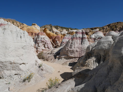 A view of a canyon road cutting between rocky areas.