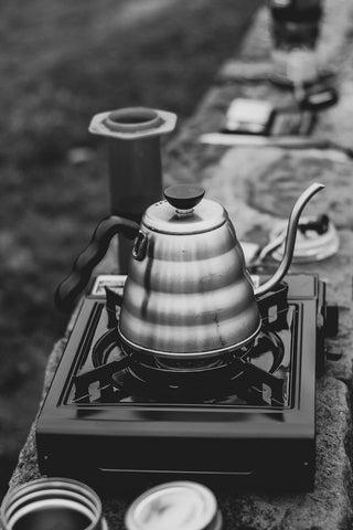 An outdoor camp stove that includes a coffeepot.