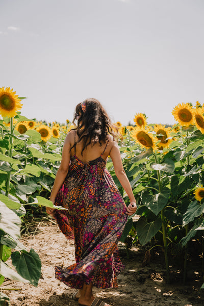 woman walking in the sunflowers in summer