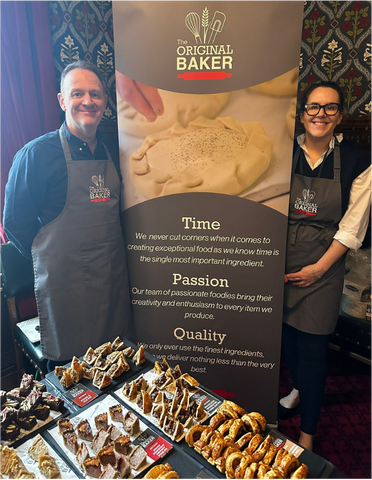 Richard and Kate with the company banner and a tray of food samples