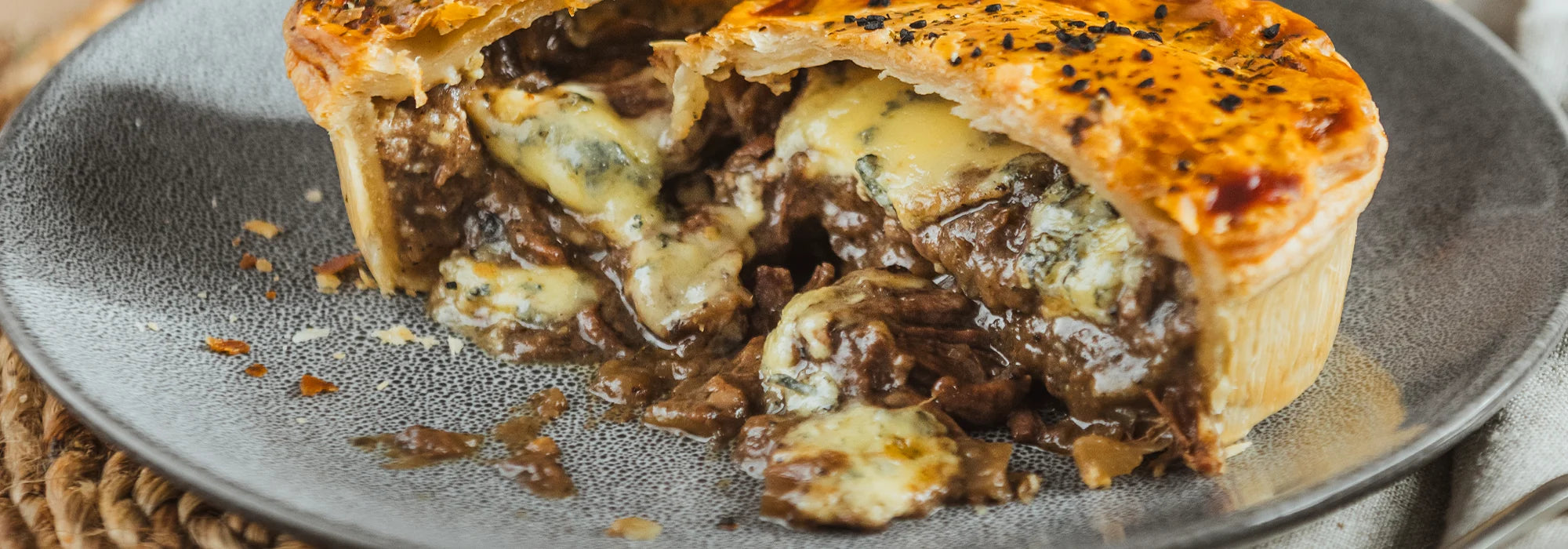 Close-up of golden pastry highlighting flaky texture and premium fillings
