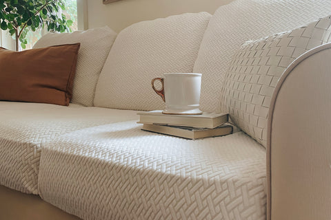 couch cover on a couch with books and a coffee cup
