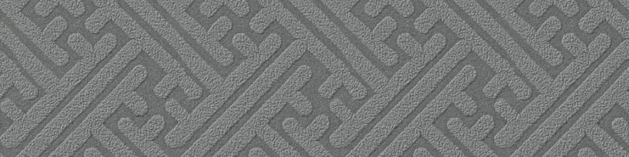 Gray textured fabric with a geometric, maze-like pattern.