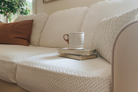 sofa covers with books and a coffee cup