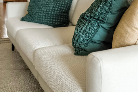 sofa with sofa covers and green pillows