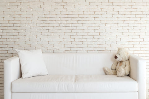 white couch with teddy bear