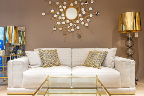 white couch with gold accessories