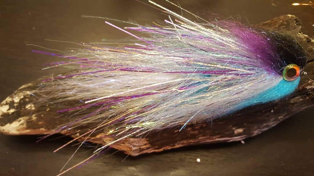 Close-up of a colorful fly used for pike fishing on Craiyon